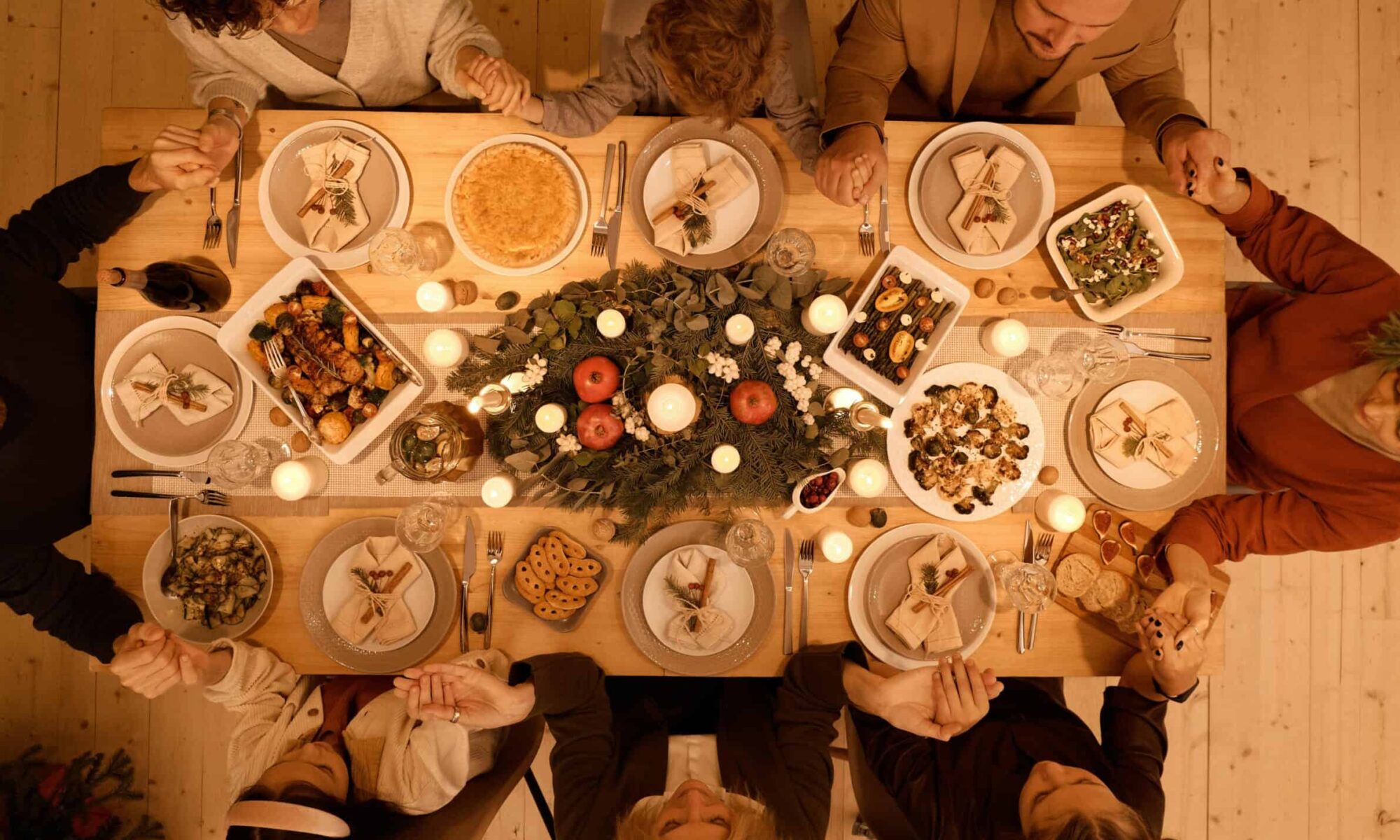 family praying to God at Thanksgiving dinner.